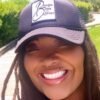 a woman wearing a hat and smiling