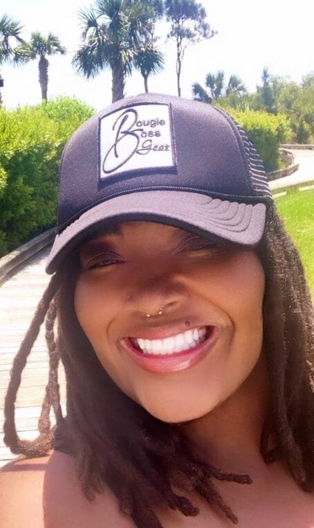 a woman wearing a hat and smiling